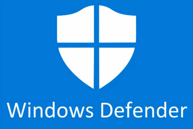 على خلفية زرقاء يظهر درع باللون الابيض مقسوم الى اربع اقسام و تحته عبارة Windows Defender باللون الابيض
