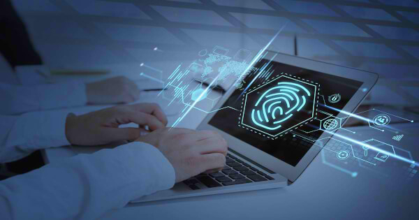 شخص ينقر على لوحة المفاتيح و تظهر على الشاشةامامه البصمة 