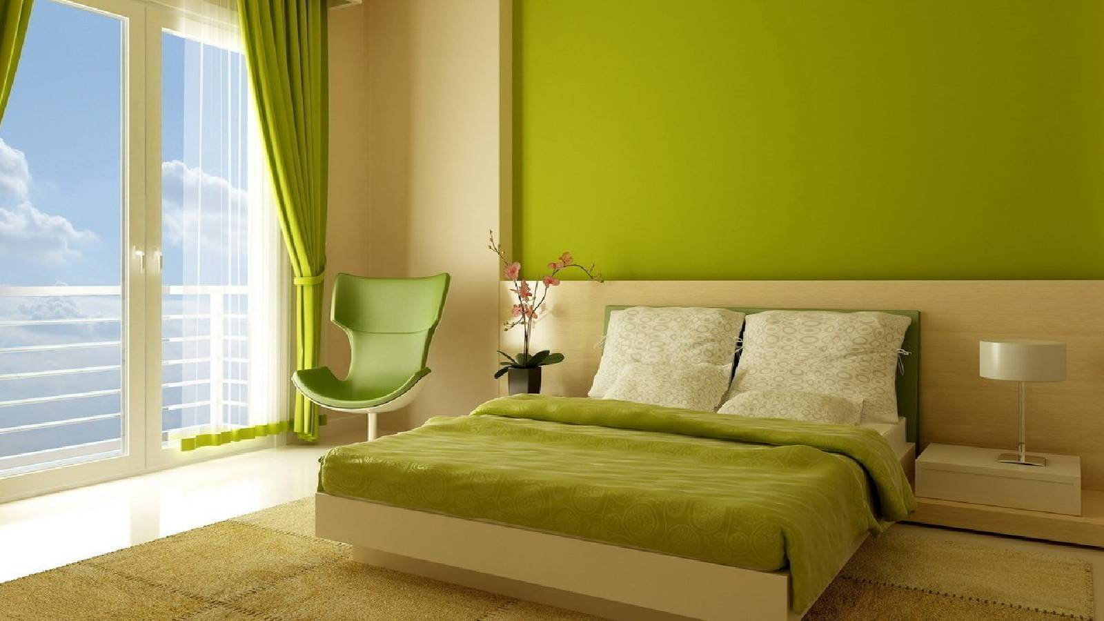 غرفة نوم يطغى عليها اللون الاخضر مع كرسي على يسار الصورة و برادي باللون الاخضر