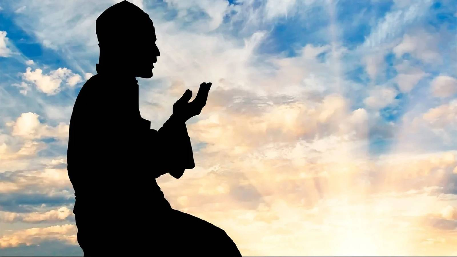 على خلفية لسماء زرقاء موشحة بالغيوم البيضاء يظهر شخص خاشع يرفع يديه بالصلاة 